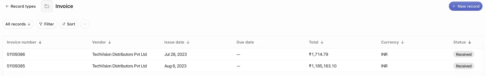 The Invoice records table with the Invoice number title column pinned to the left, the view toolbar above it, and a New record button